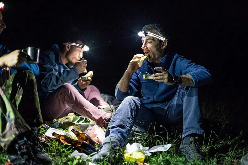 Motion-sensitive LED headlight with COB flashlight for camping and fishing excursions.