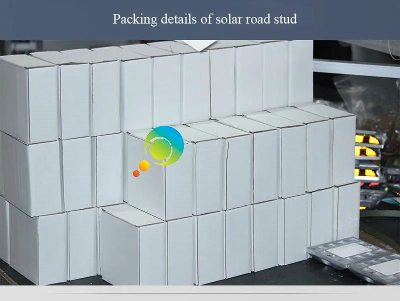 Packaging includes: solar-powered road stud with white plastic base and green LED light.