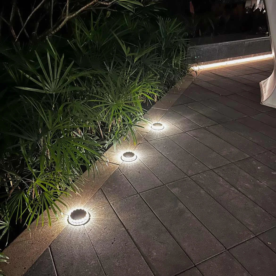 4Pack Solar Ground Light, Durable, waterproof LED solar lights for outdoor use on lawns, paths, and patios.