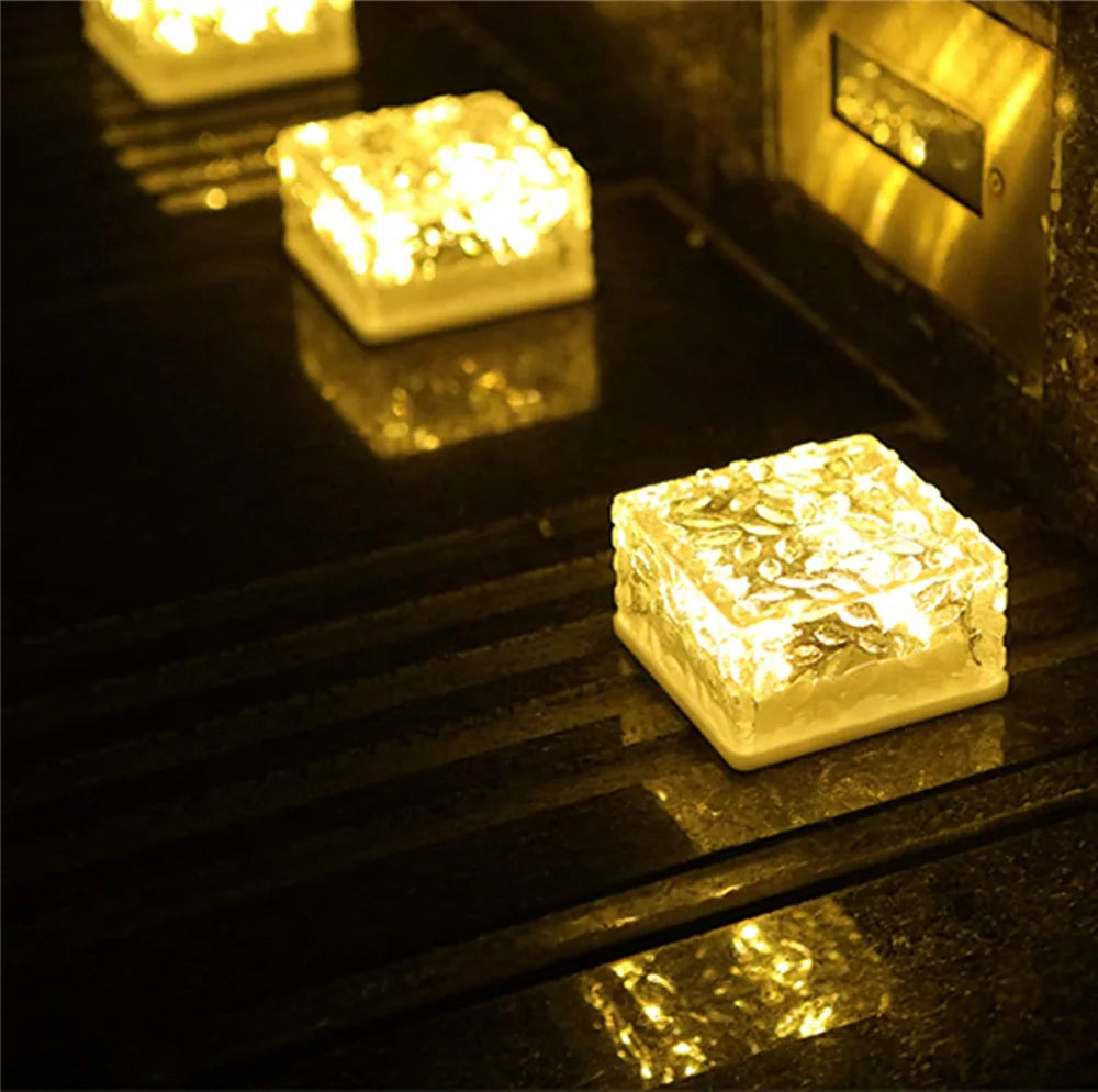 Solar Brick Ice Cube Light, Energy-efficient solar brick lights provide warm illumination for outdoor spaces like patios and pathways.