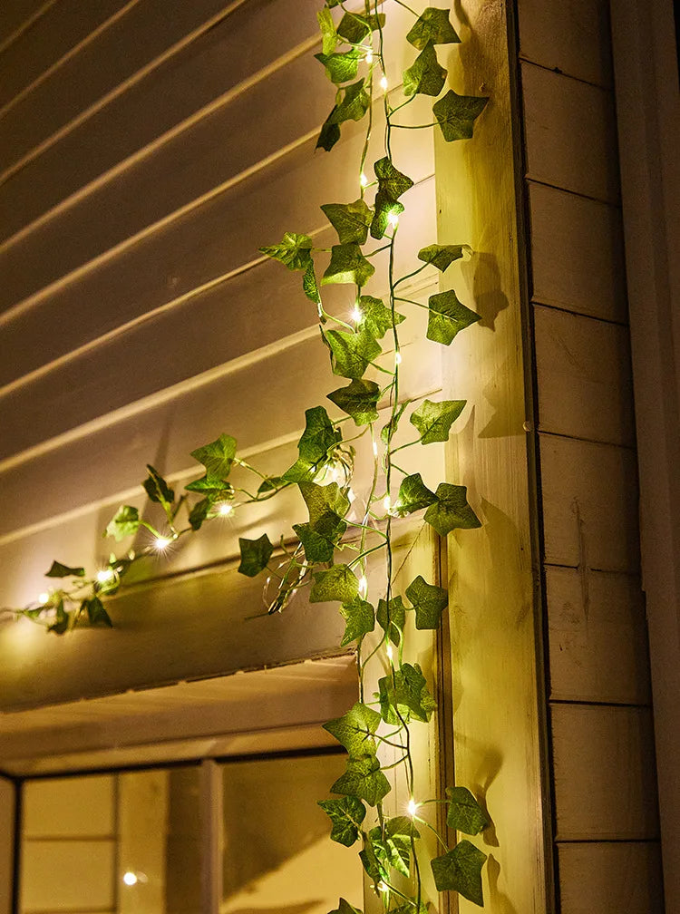 Solar-powered lamp with lithium battery, incandescent bulbs, and green ivy leaf design.