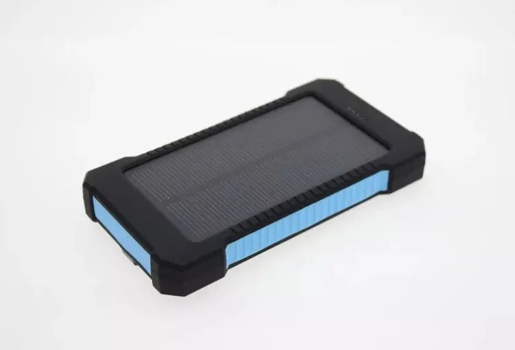 Rugged power bank with solar panel, wireless charging, and multiple functions for outdoor use.