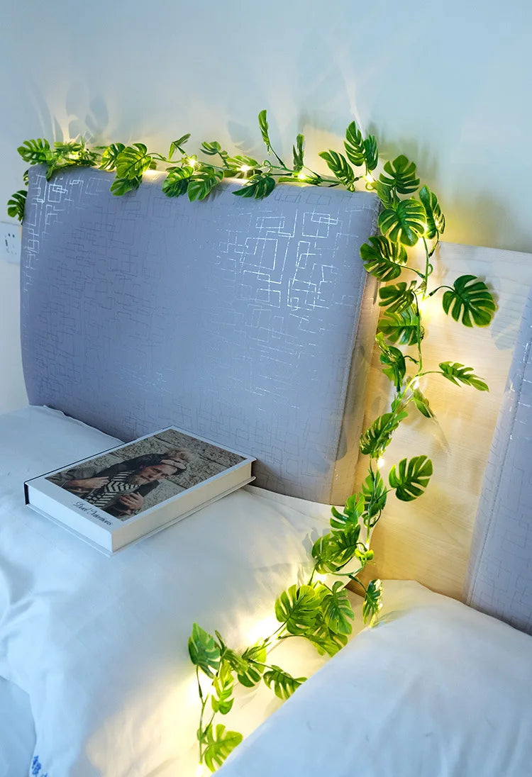 Elegant solar-powered garland with copper LED lights and ivy leaf design for outdoor gardens.